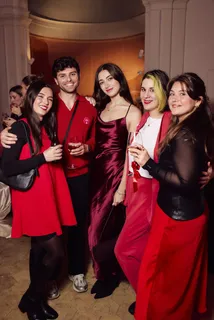 Five guests in red posing together