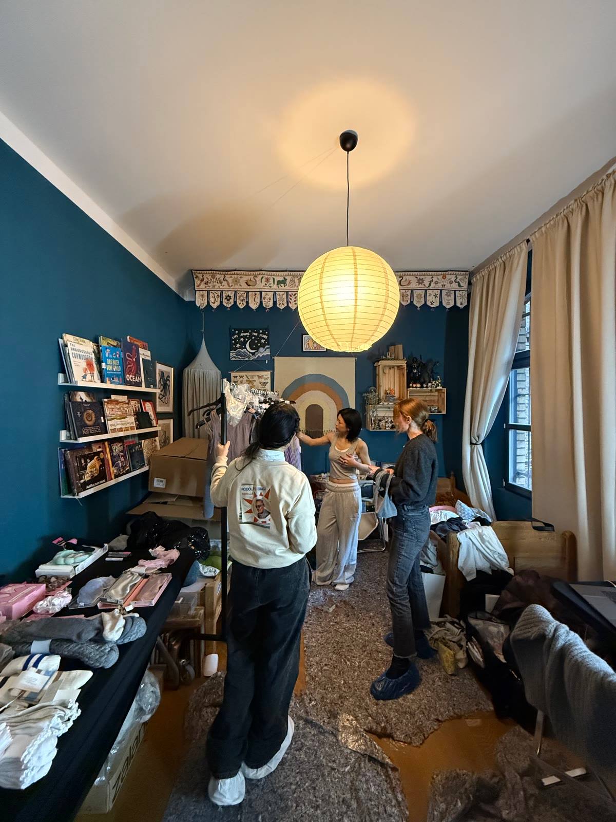 The styling room with rails and folded looks, the team choosing outfits